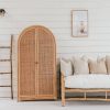 rattan arch cupboard next to a teak lounge