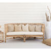 large rattan lounge against white wall