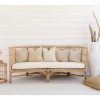 large rattan lounge against white wall