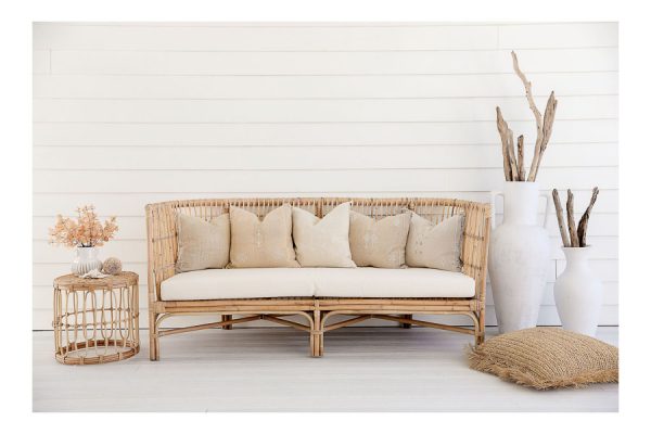 large rattan lounge against white wall