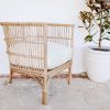 rattan chair against white wall
