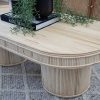 rattan coffee table on grey rug