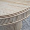 rattan coffee table on grey rug