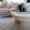 rattan coffee table on grey rug
