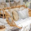 outdoor hanging chair with white pillows and throw