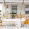 huge hanging chair with white pillows and a throw