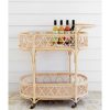 rattan bar cart with colourful drinks on shelf