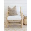 teak chair with white seat covers and grey pillows