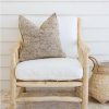 teak chair with white seat covers and grey pillows