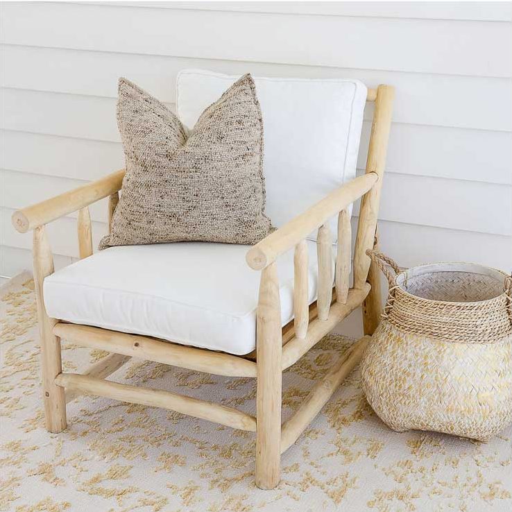 teak chair with white seat covers and grey pillow