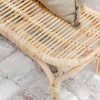 rattan bench seat with grey cushions on top