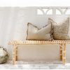 rattan bench seat with grey cushions on top