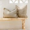 rattan bench seat with grey cushions on top