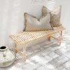 rattan bench seat with grey cushions on top