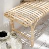 rattan bench seat with grey cushions on top