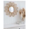 rattan round mirror hanging over white console