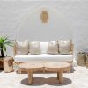 raw round coffee table with white lounge setting