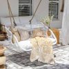 white hanging chair with yellow throw